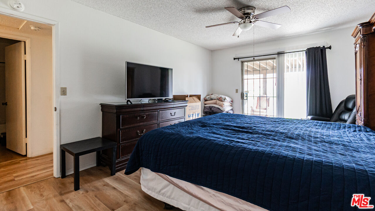 586 San Dimas Street Hemet, CA 92545 - Photo 15 of 30 a bedroom with a bed and a flat screen tv