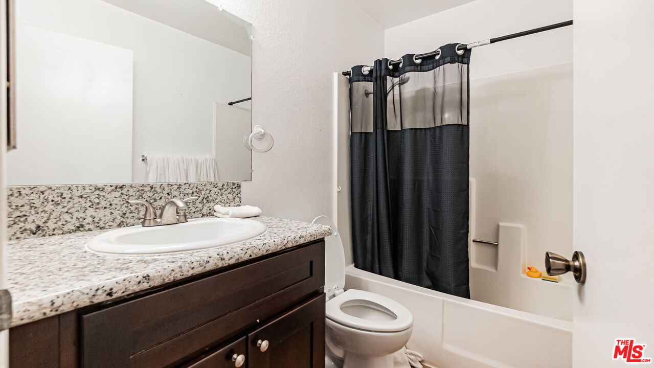 586 San Dimas Street Hemet, CA 92545 - Photo 19 of 30 a bathroom with a granite countertop sink toilet and shower