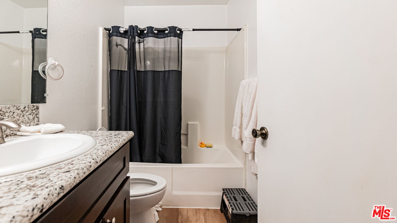 586 San Dimas Street Hemet, CA 92545 - Photo 20 of 30 a bathroom with a granite countertop sink toilet and shower