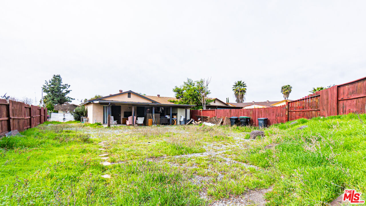 586 San Dimas Street Hemet, CA 92545 - Photo 24 of 30 a view of a house with table and chairs under an umbrella