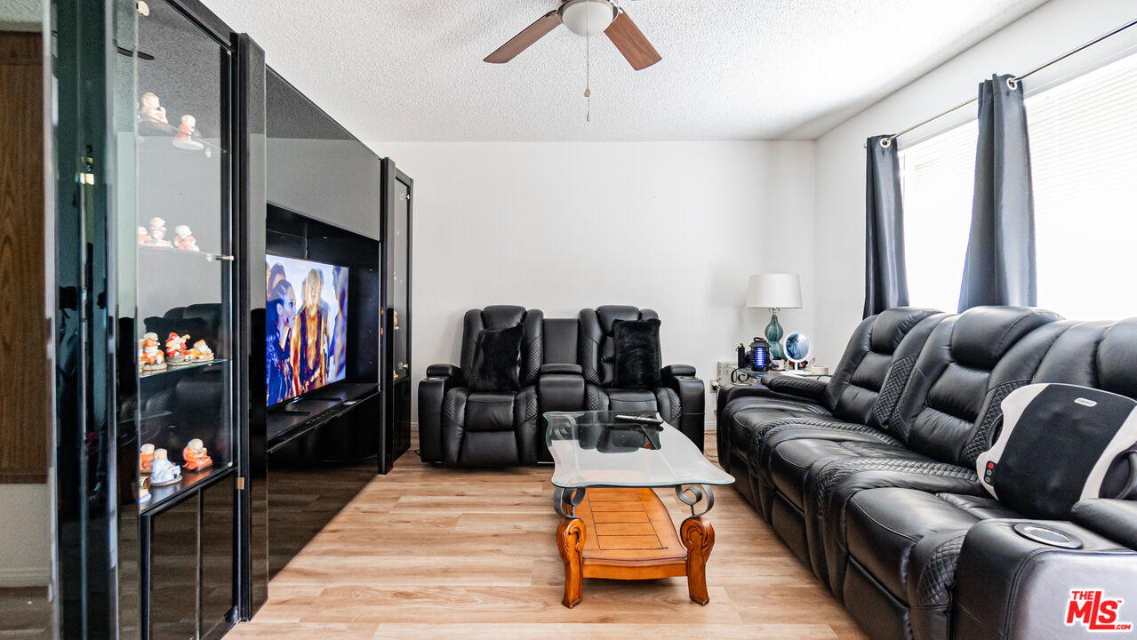586 San Dimas Street Hemet, CA 92545 - Photo 5 of 30 a living room with furniture ceiling fan and a rug