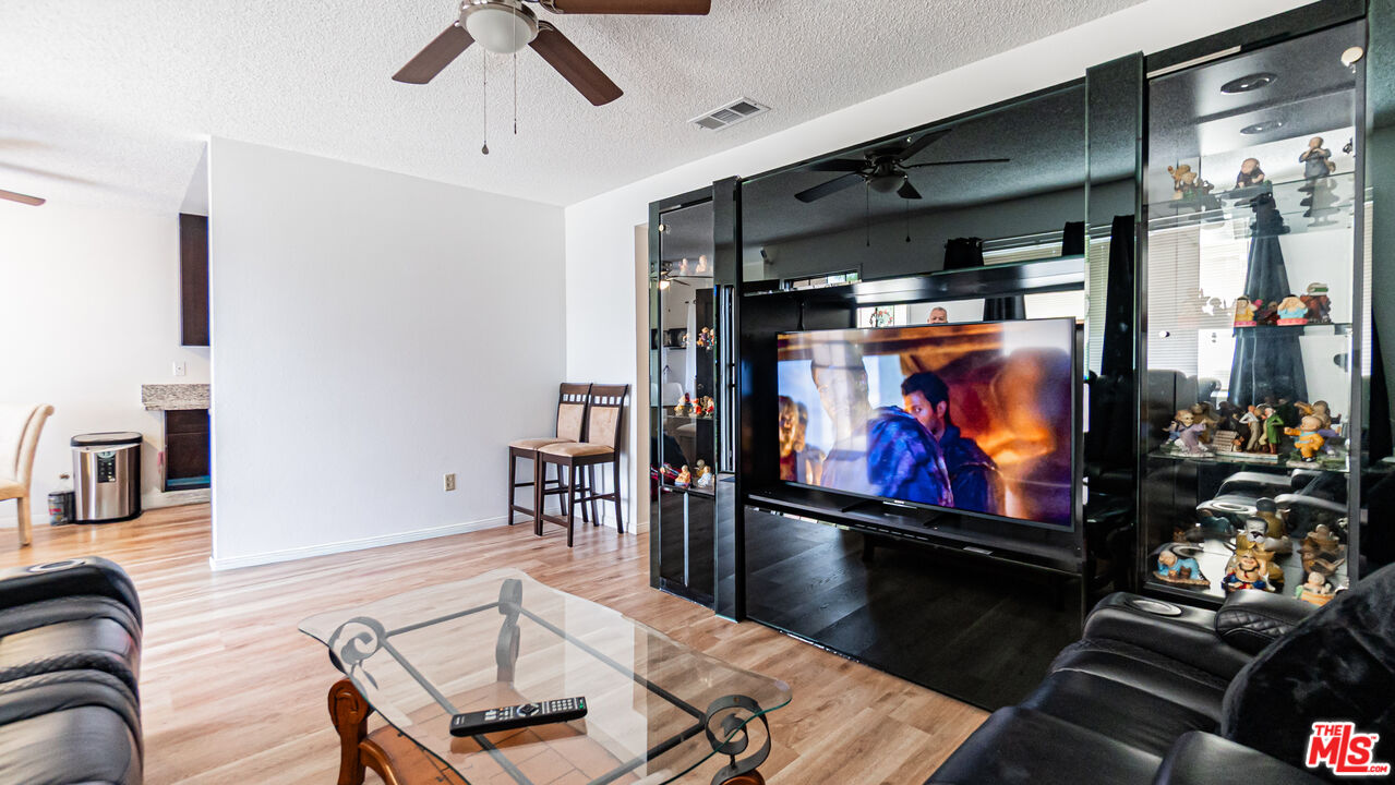 586 San Dimas Street Hemet, CA 92545 - Photo 6 of 30 a room with furniture projector and screen