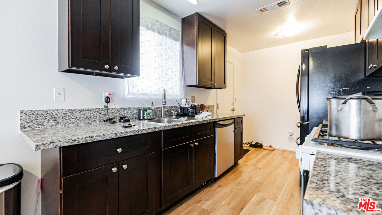 586 San Dimas Street Hemet, CA 92545 - Photo 10 of 30 a kitchen with a sink stove and microwave