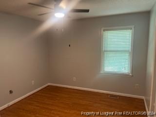 394 Wrench Road Godwin, NC 28344 - Photo 13 of 20 an empty room with wooden floor and windows