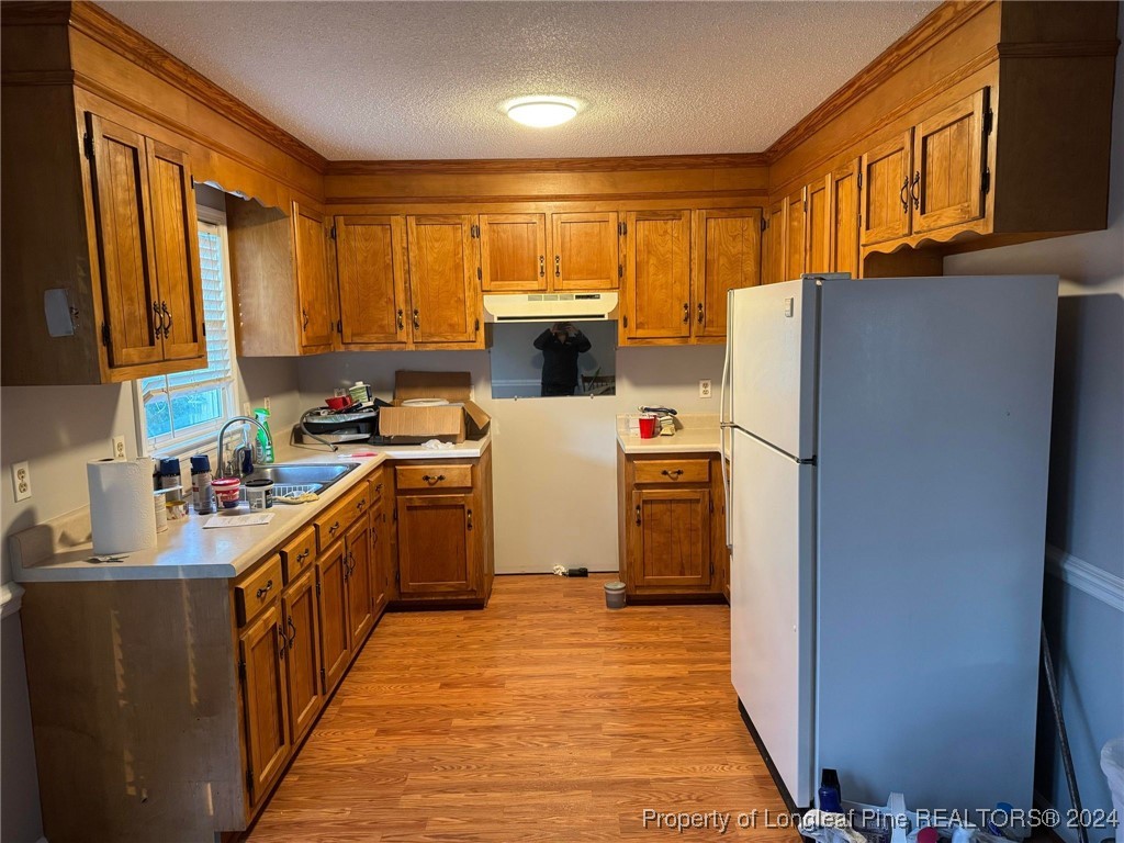 394 Wrench Road Godwin, NC 28344 - Photo 5 of 20 a kitchen with a refrigerator a stove top oven a sink and dishwasher