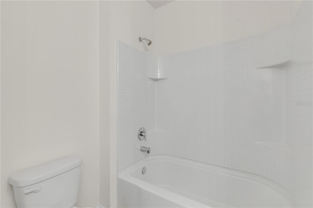 48 Hickory Loop Ocala, FL 34472 - Photo 39 of 52 a white bath tub sitting next to a white toilet and vanity