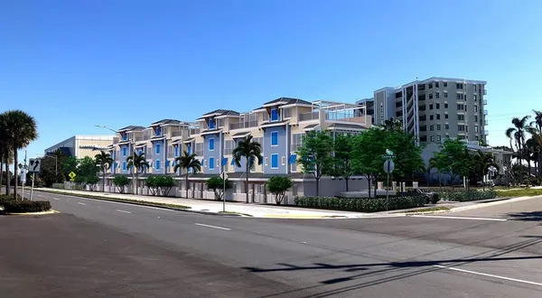 a city street with tall buildings in the background