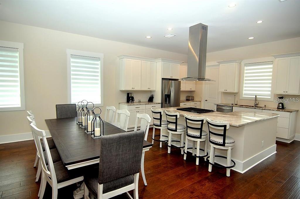 16 Outlook Way, Unit 9 Dunedin, FL 34698 - Photo 36 of 77 a view of a dining room with furniture and wooden floor