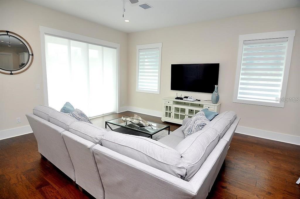 16 Outlook Way, Unit 9 Dunedin, FL 34698 - Photo 40 of 77 a living room with furniture and a flat screen tv