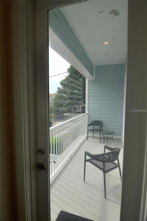 16 Outlook Way, Unit 9 Dunedin, FL 34698 - Photo 42 of 77 a view of a room with a bench and wooden floor