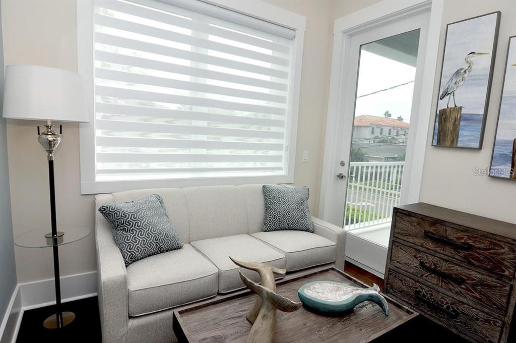 16 Outlook Way, Unit 9 Dunedin, FL 34698 - Photo 43 of 77 a living room with furniture and a window