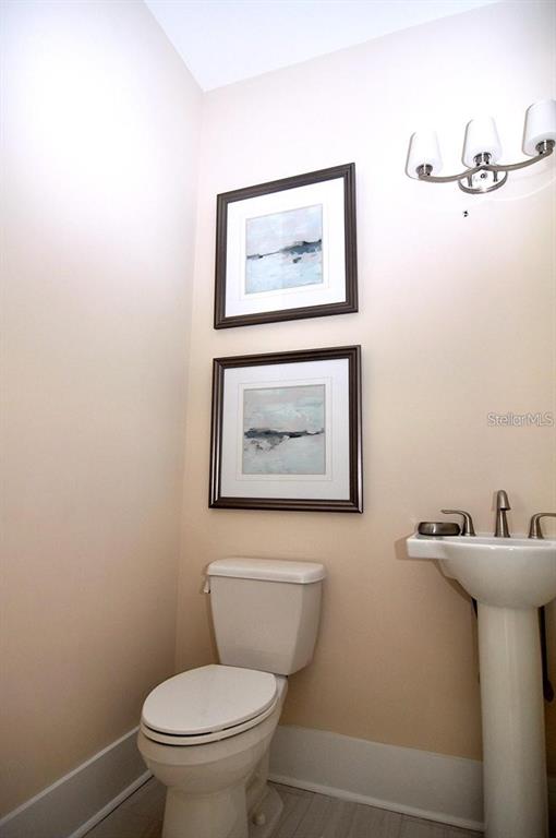 16 Outlook Way, Unit 9 Dunedin, FL 34698 - Photo 44 of 77 a bathroom with a toilet a sink and mirror