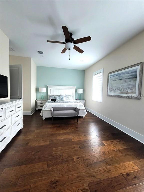 16 Outlook Way, Unit 9 Dunedin, FL 34698 - Photo 58 of 77 a spacious bedroom with a bed and a flat tv screen on dresser