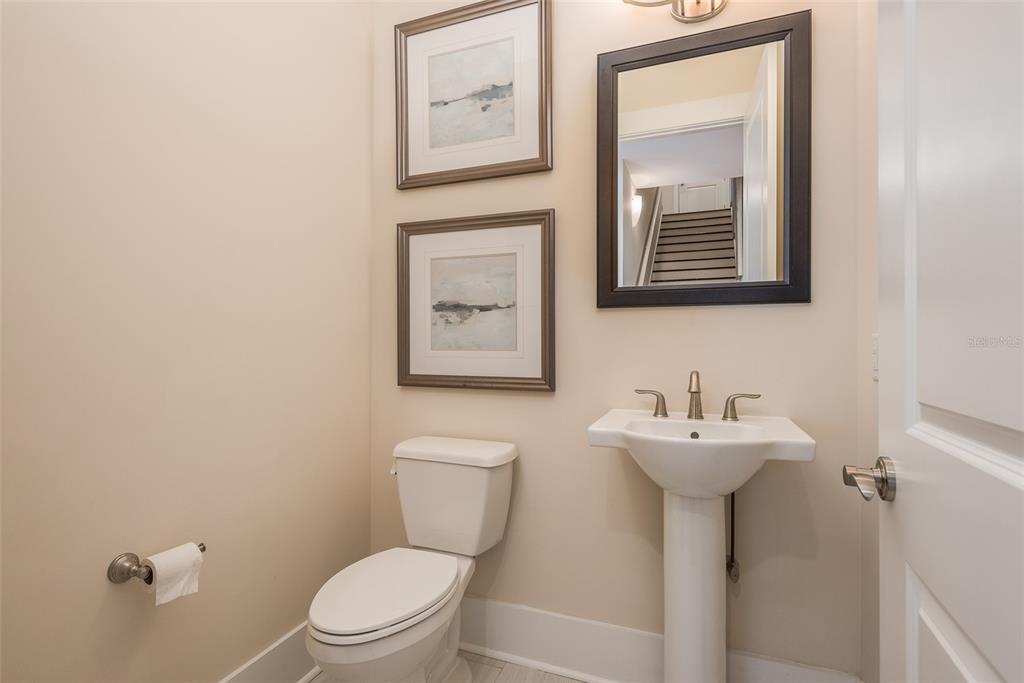 16 Outlook Way, Unit 9 Dunedin, FL 34698 - Photo 67 of 77 a bathroom with a toilet sink and mirror