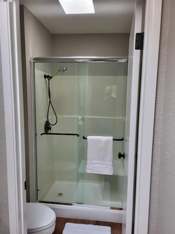 a bathroom with a glass shower door
