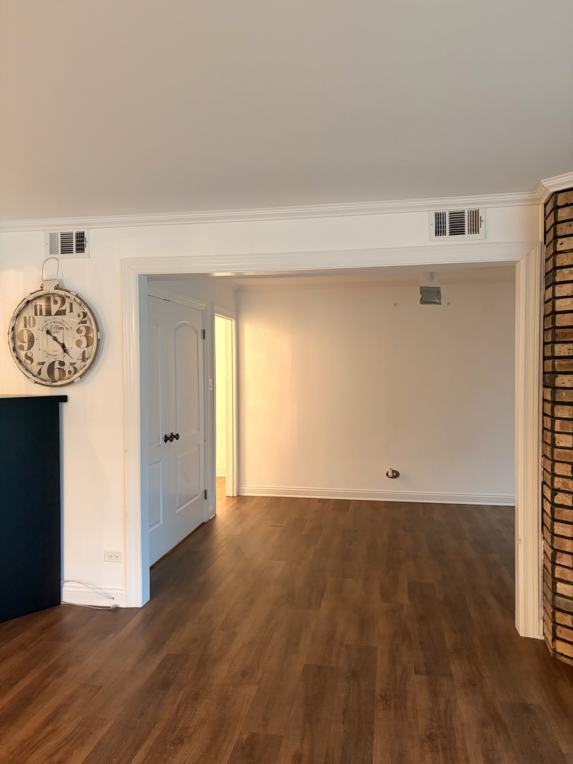 9194 S Road, Unit B Palos Hills, IL 60465 - Photo 5 of 10 a view of an empty room with wooden floor