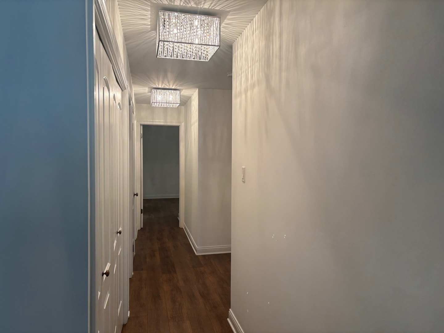 9194 S Road, Unit B Palos Hills, IL 60465 - Photo 10 of 10 a view of a hallway with wooden floor and a chandelier
