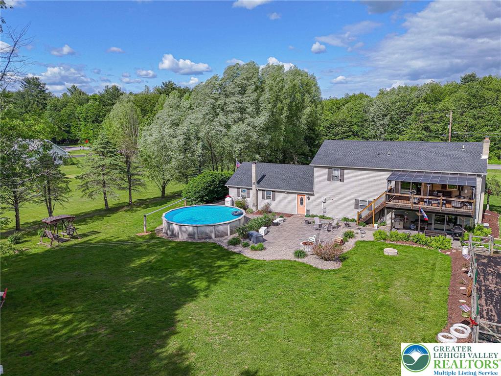 341 Lower Greenhill Road Kunkletown, PA 18058 - Photo 57 of 69 A spacious backyard retreat features an above-ground pool, patio area, and a generous deck with scenic views.