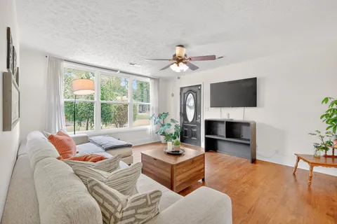 a kitchen with granite countertop stainless steel appliances a stove cabinets and a refrigerator
