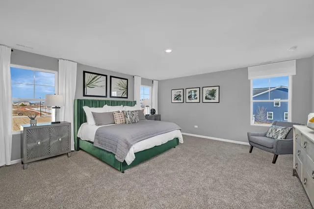 a spacious bedroom with a bed and a couch