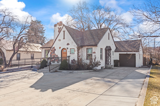 465 North Main Street Richfield, UT 84701 - Photo 2 of 43 View of front of house with stucco siding, roof with shingles, concrete driveway, a garage, and a chimney