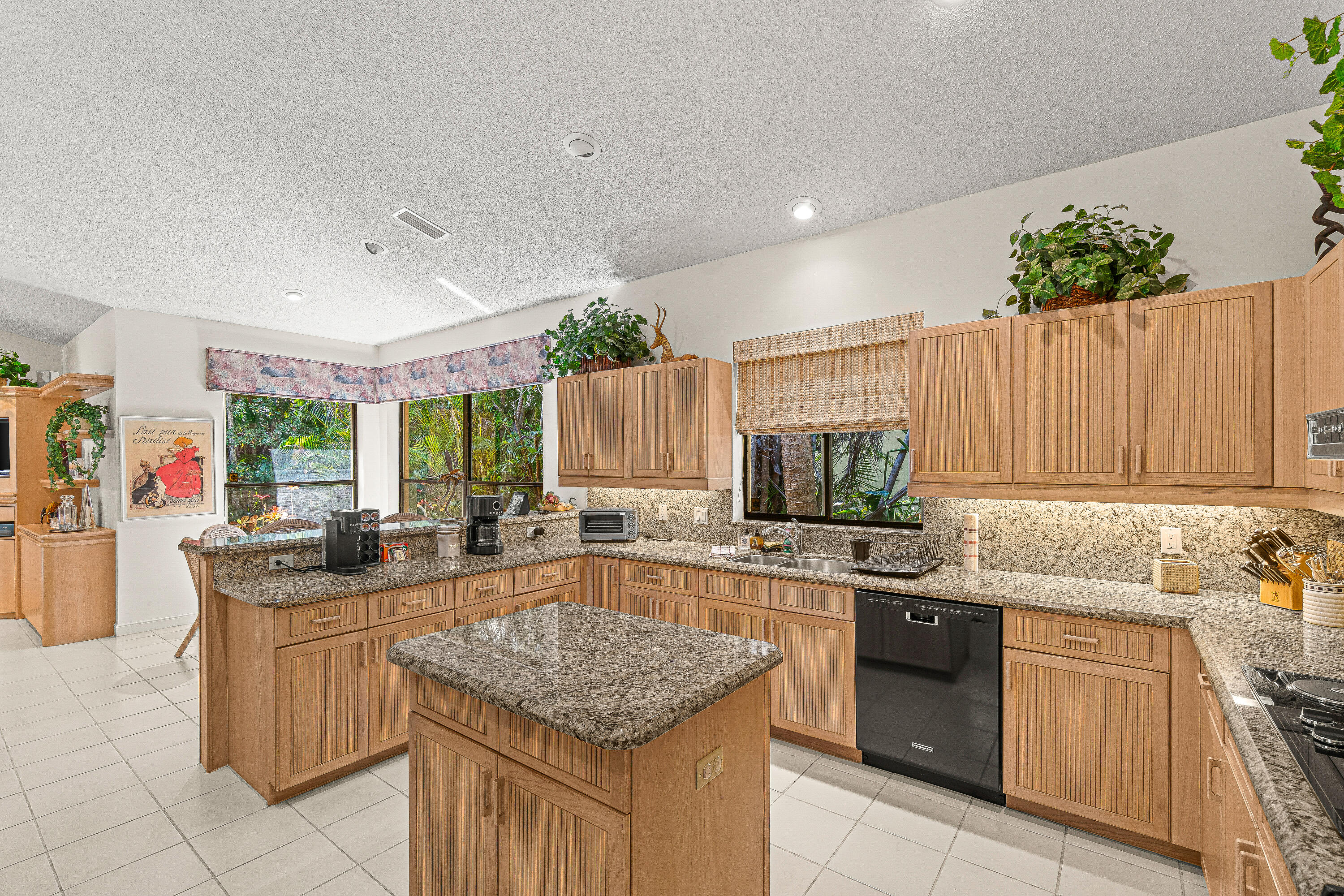 2250 Northwest 59th Street Boca Raton, FL 33496 - Photo 6 of 22 a kitchen with a sink stove and cabinets