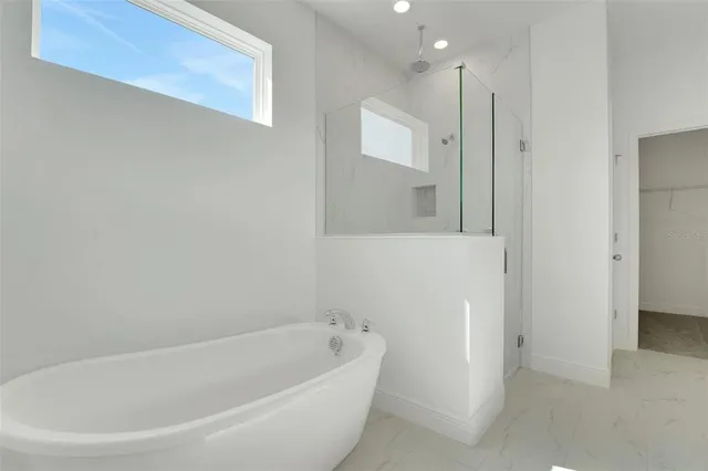 a white bath tub sitting in a bathroom