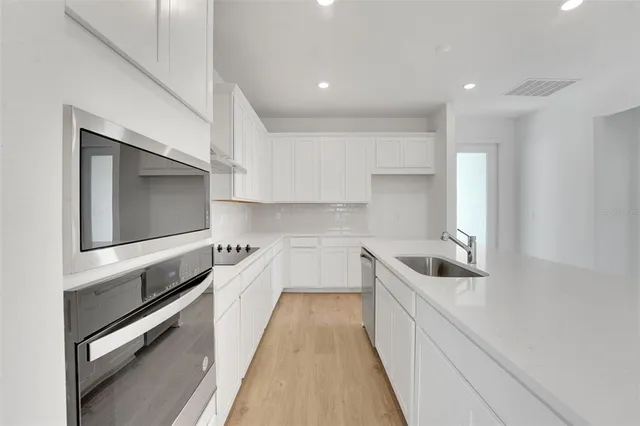 a kitchen with counter top space and stainless steel appliances