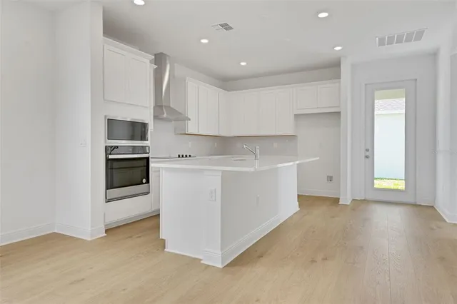 a view of kitchen with cabinets and oven