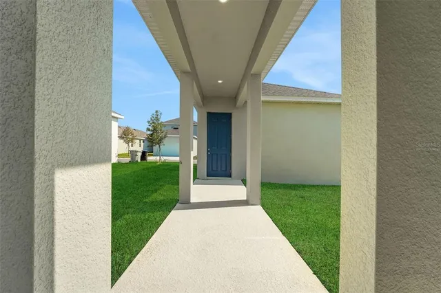 a view of a house with a backyard