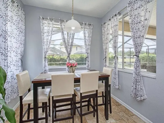 a dining room with furniture a chandelier and wooden floor