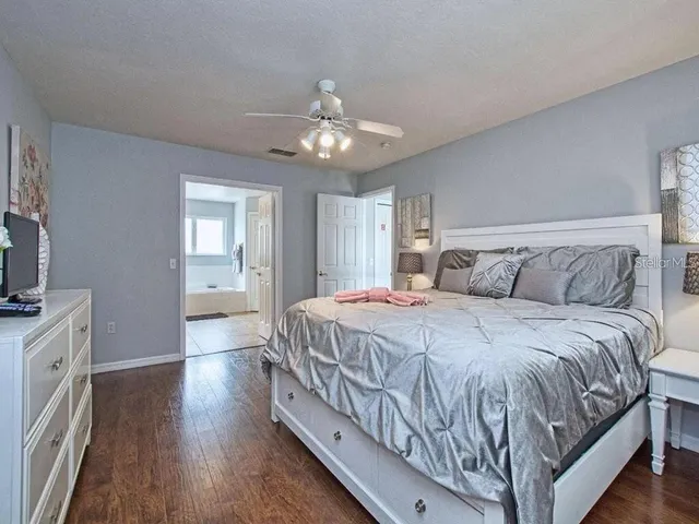a bedroom with a large bed and a chandelier