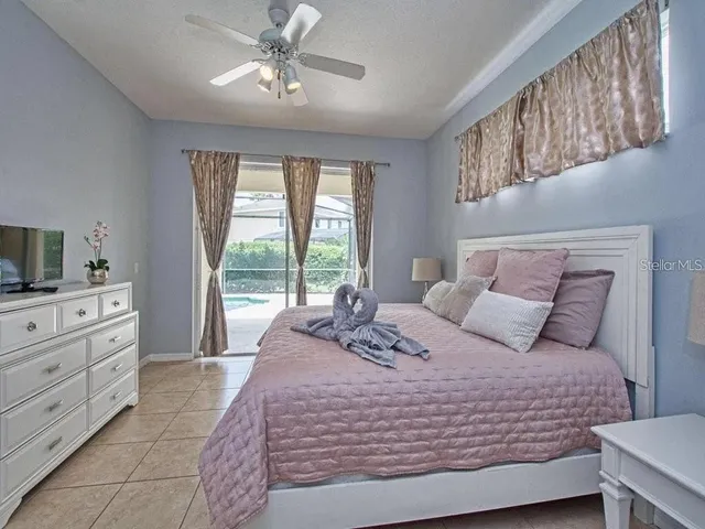 a large bed sitting in a bedroom next to a window