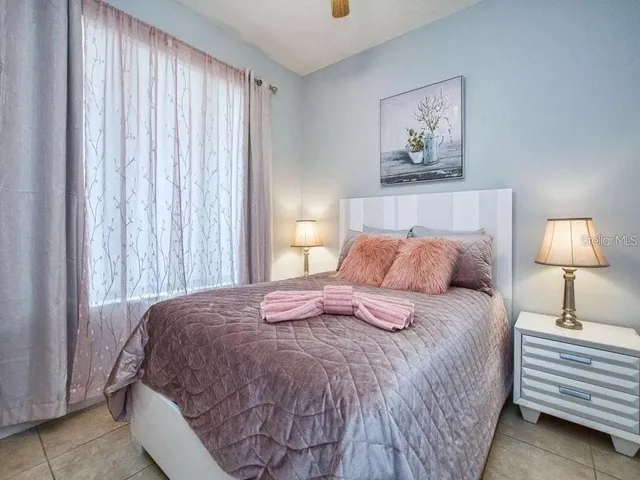 a bedroom with a bed and a lamp