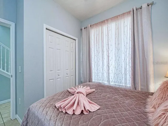 a bedroom with a bed and a curtain