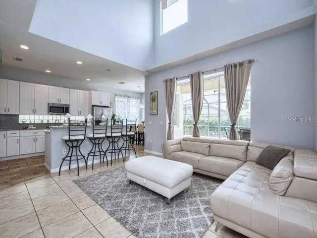 a living room with furniture and kitchen view