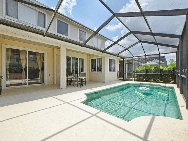 a view of a house with backyard porch and sitting area