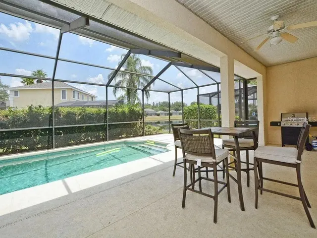 a view of a patio with a table chairs and a backyard