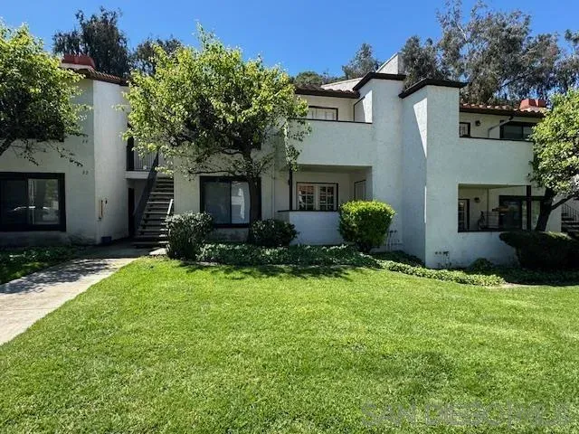 a sign broad in front of the red tree