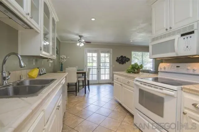 a kitchen with a stove sink and refrigerator