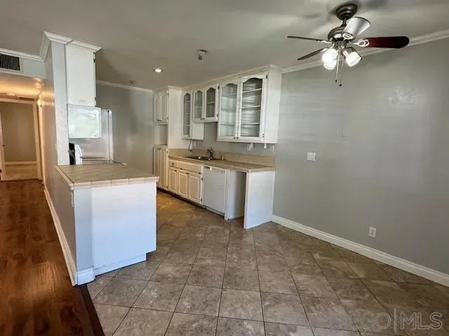an empty room with wooden floor fireplace and windows