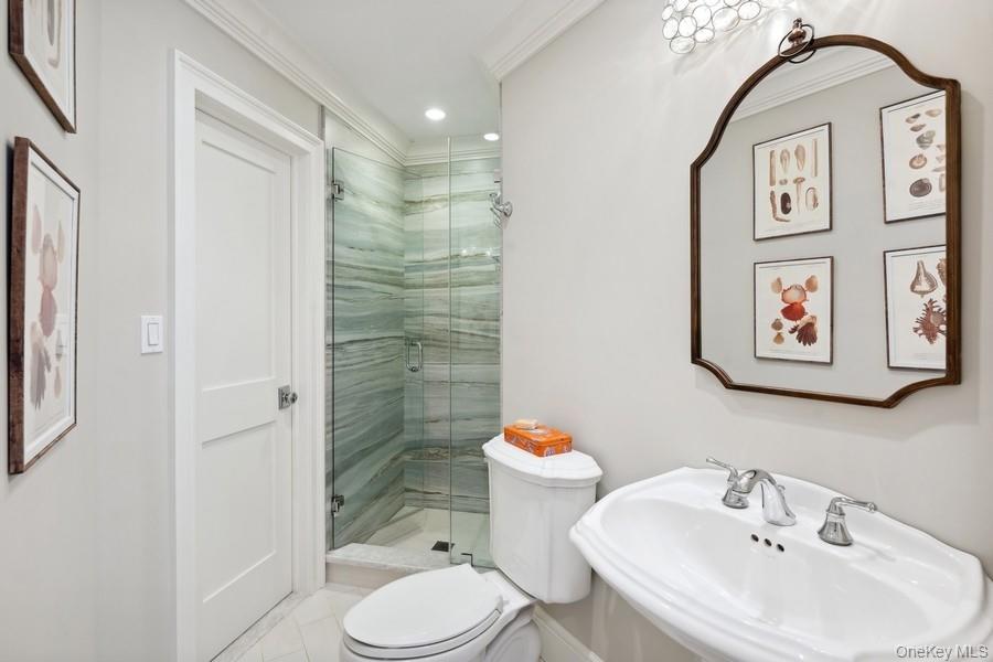 39 Smugglers Path Riverhead, NY 11901 - Photo 13 of 47 a bathroom with a sink toilet and shower