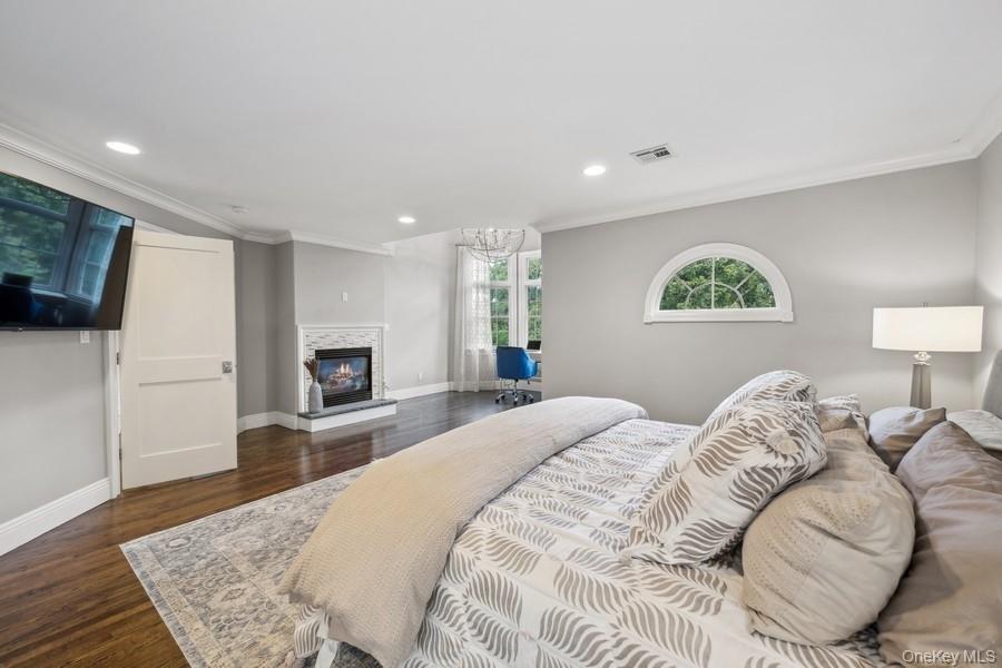 39 Smugglers Path Riverhead, NY 11901 - Photo 20 of 48 a bedroom with a large bed and a couch