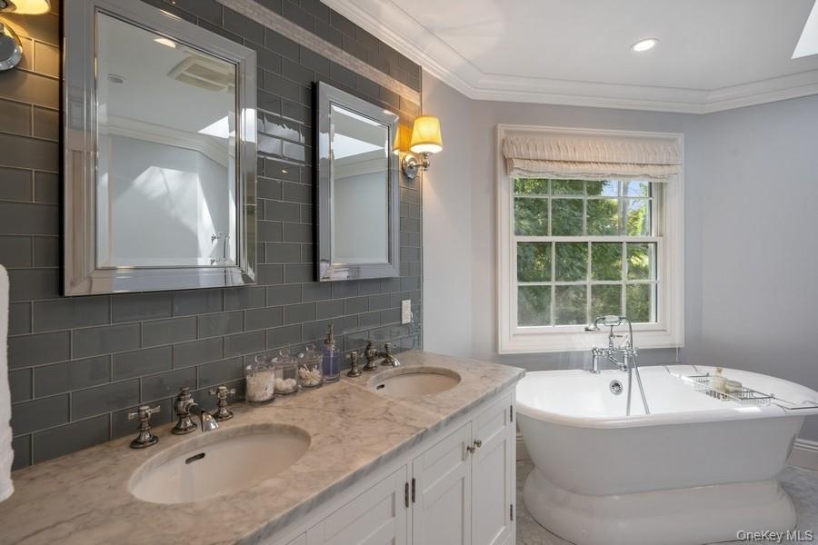 39 Smugglers Path Riverhead, NY 11901 - Photo 24 of 48 a bathroom with a sink and a bathtub