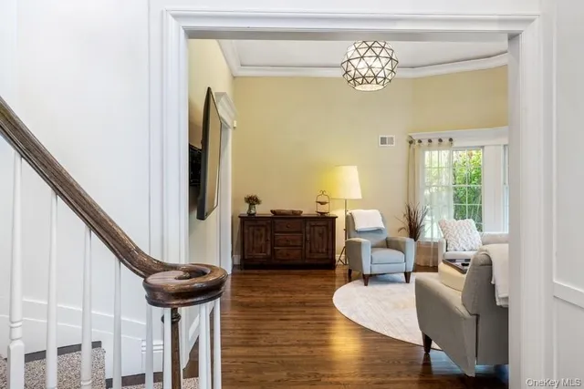 a living room with furniture and a chandelier