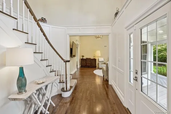 a view of entryway and hall with wooden floor