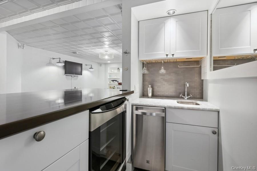39 Smugglers Path Riverhead, NY 11901 - Photo 31 of 48 a kitchen with a sink a stove and cabinets