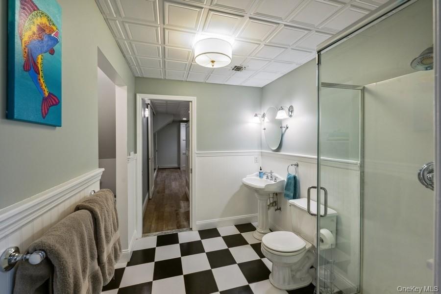 39 Smugglers Path Riverhead, NY 11901 - Photo 32 of 47 a bathroom with a sink a toilet and shower