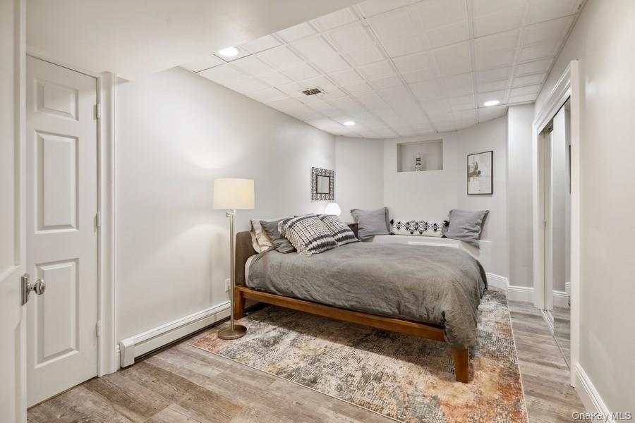 39 Smugglers Path Riverhead, NY 11901 - Photo 34 of 48 a spacious bedroom with a bed and a lamp