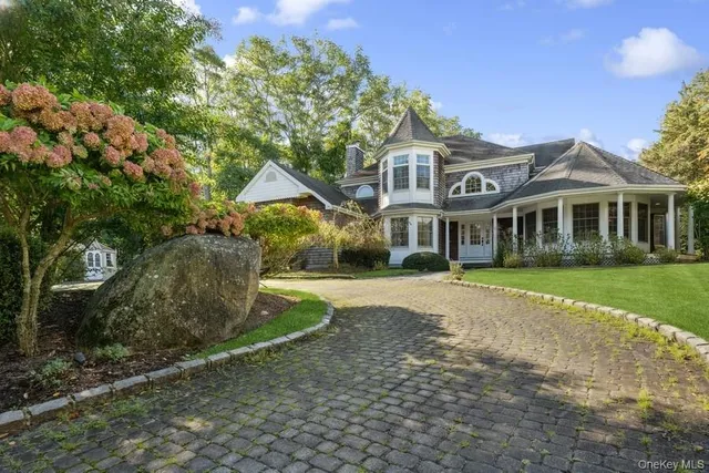 a view of a patio with a dining table and chairs under an umbrella